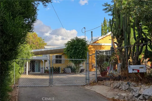 a view of a house with a tree in front