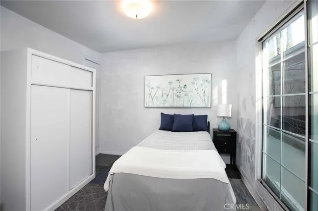 a bedroom with a bed and a window