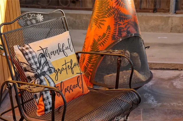 a patio with a table and chairs under an umbrella
