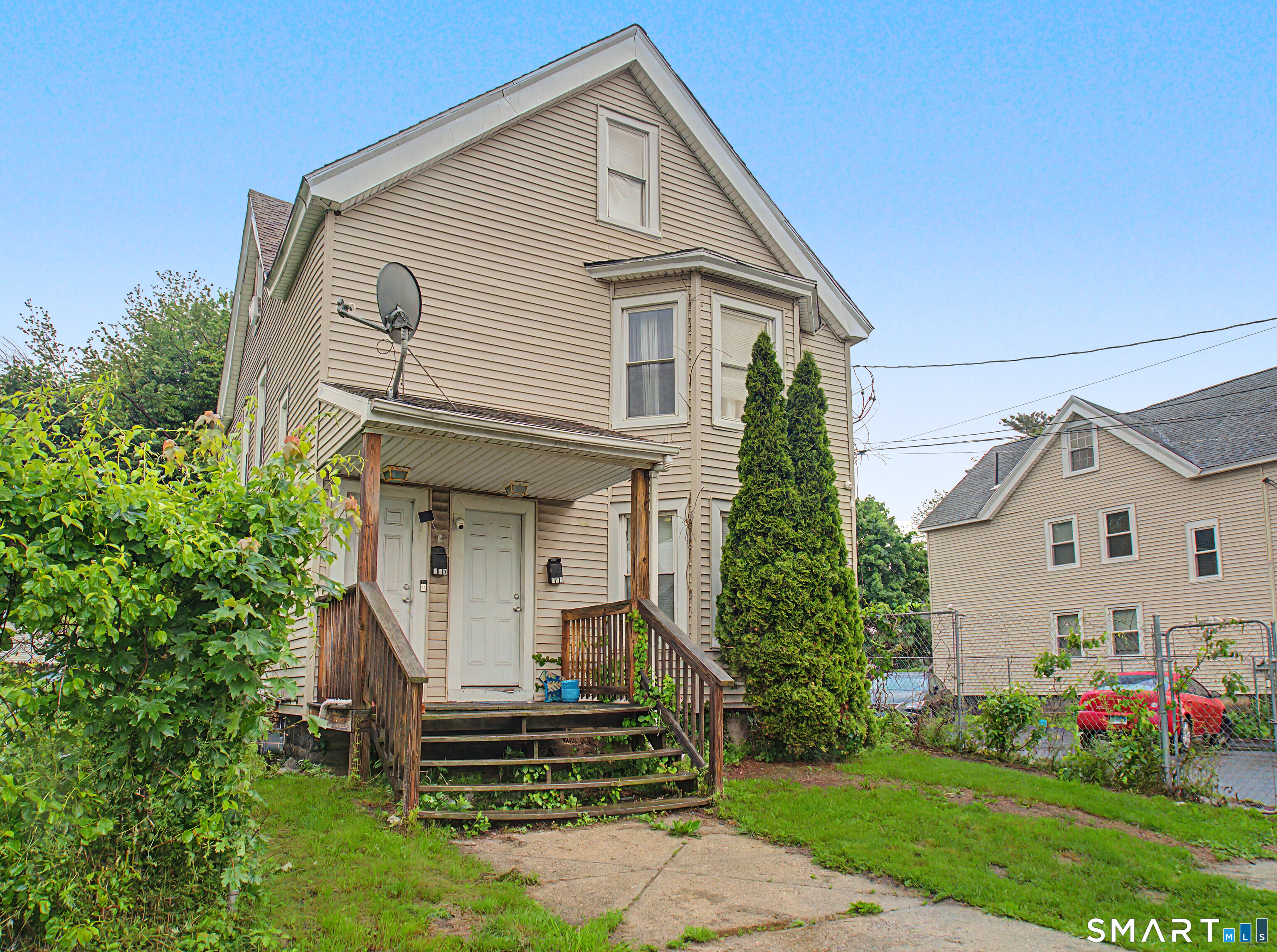 319 Carroll Avenue Bridgeport, CT 06607 - Photo 4 of 40 a front view of a house with a garden