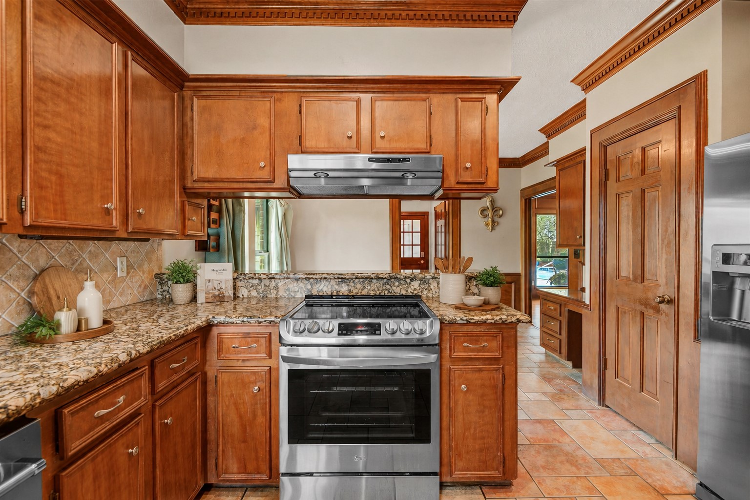 8412 Hidden Trail Lane Spring, TX 77379 - Photo 12 of 36 *Digitally Enhanced Decor** The kitchen features granite counters, abundant cabinetry, and a convenient breakfast bar overlooking the adjoining living space.