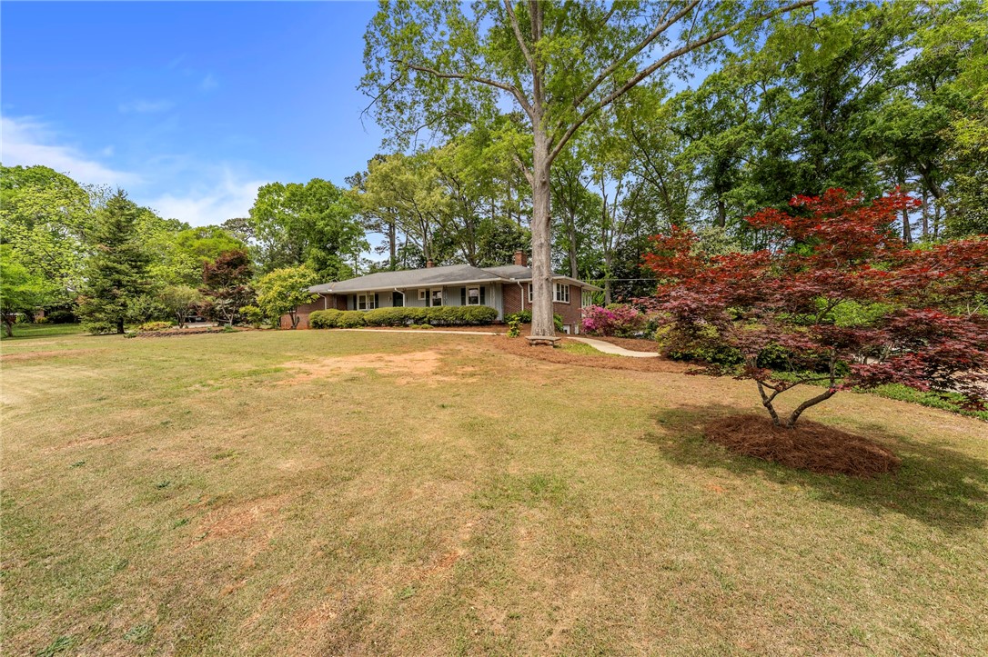 1105 Greenacres Anderson, SC 29621 - Photo 2 of 46 Mature trees and lush landscaping provide natural serenity for this inviting ranch-style residence.