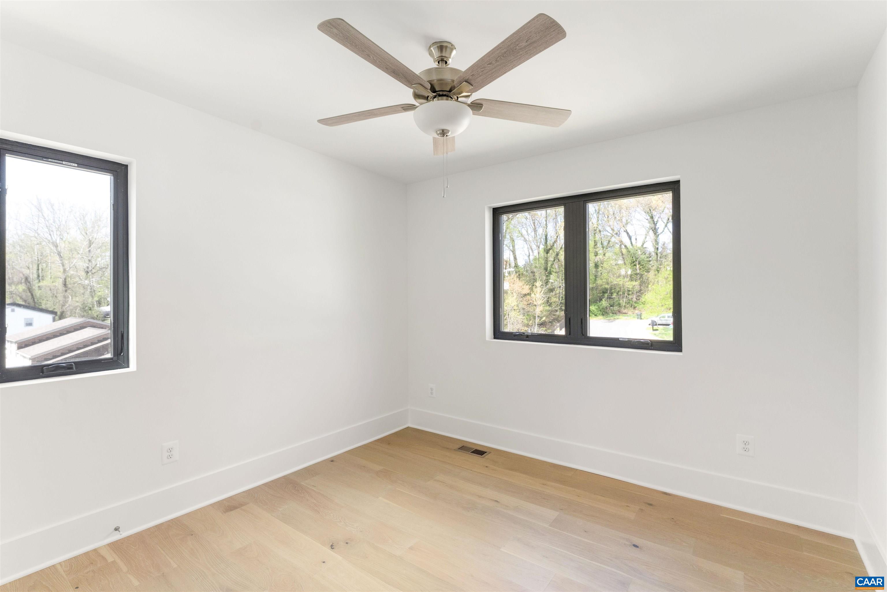 983 5th Street Southwest Charlottesville, VA 22903 - Photo 23 of 33 an empty room with a window and a ceiling fan