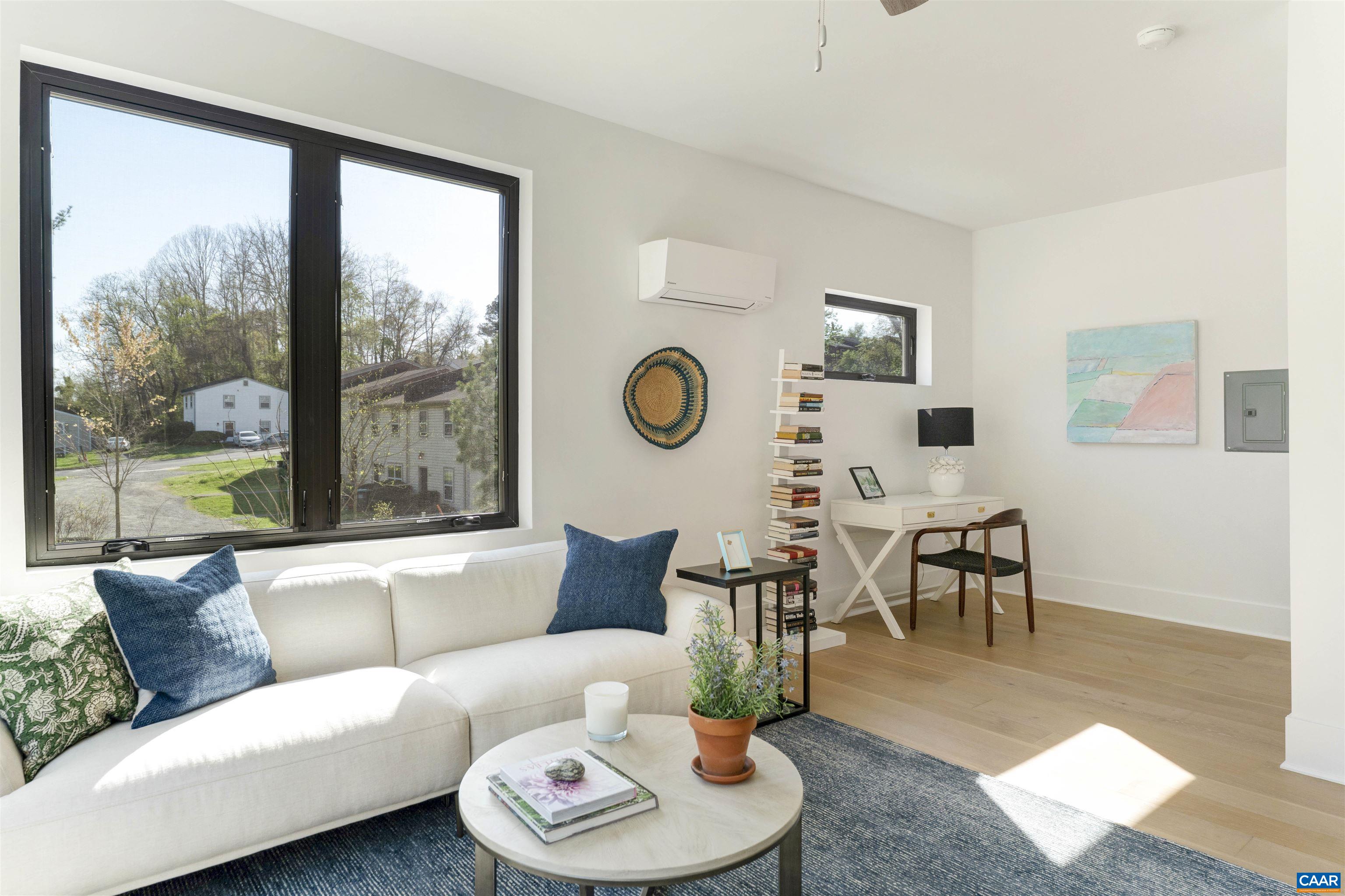 983 5th Street Southwest Charlottesville, VA 22903 - Photo 28 of 33 a living room with furniture a rug potted plant and a large window