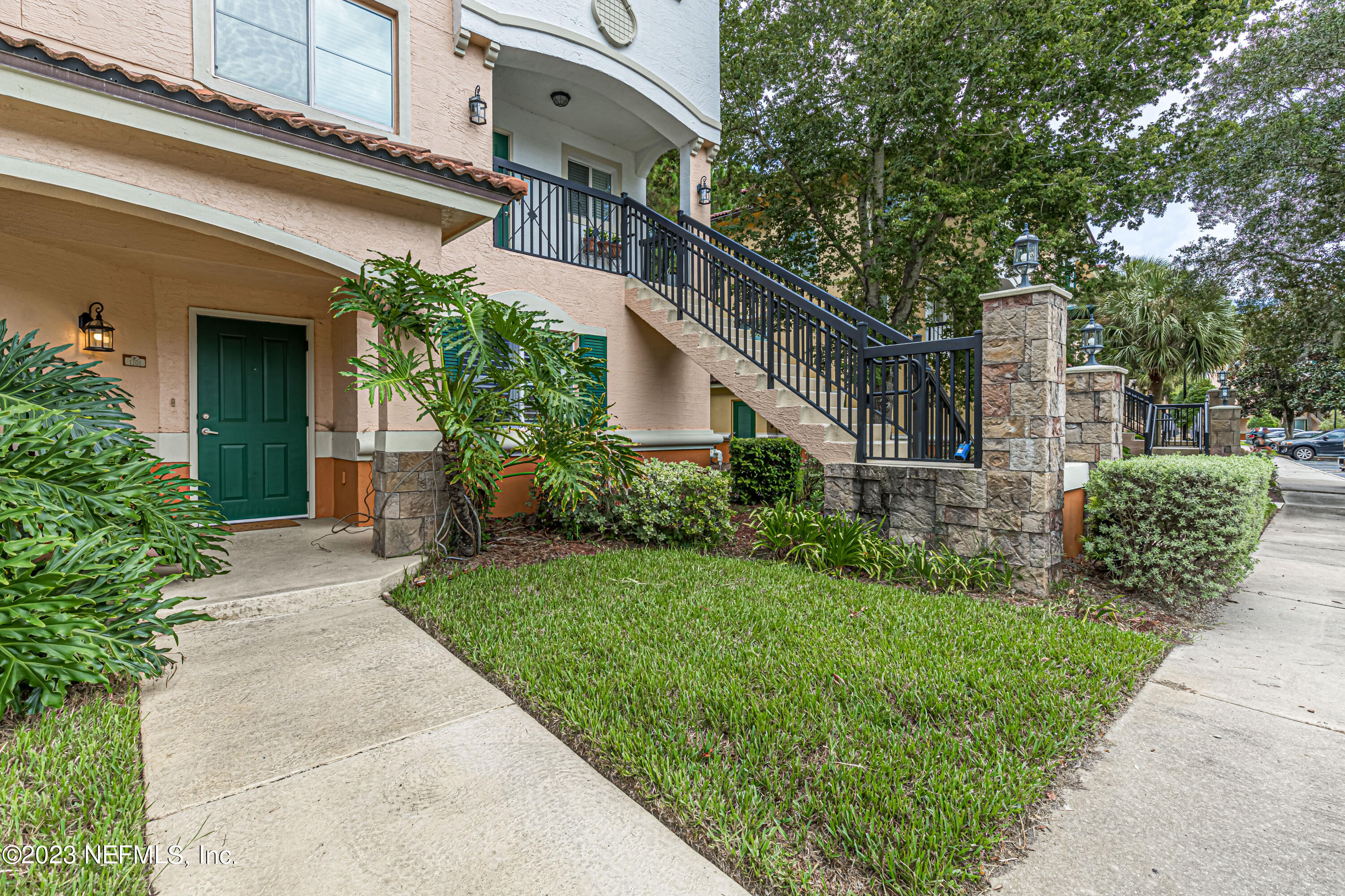 9745 Touchton Road, Unit 1105 Jacksonville, FL 32246 - Photo 1 of 64 a view of a house with brick walls and a yard with plants
