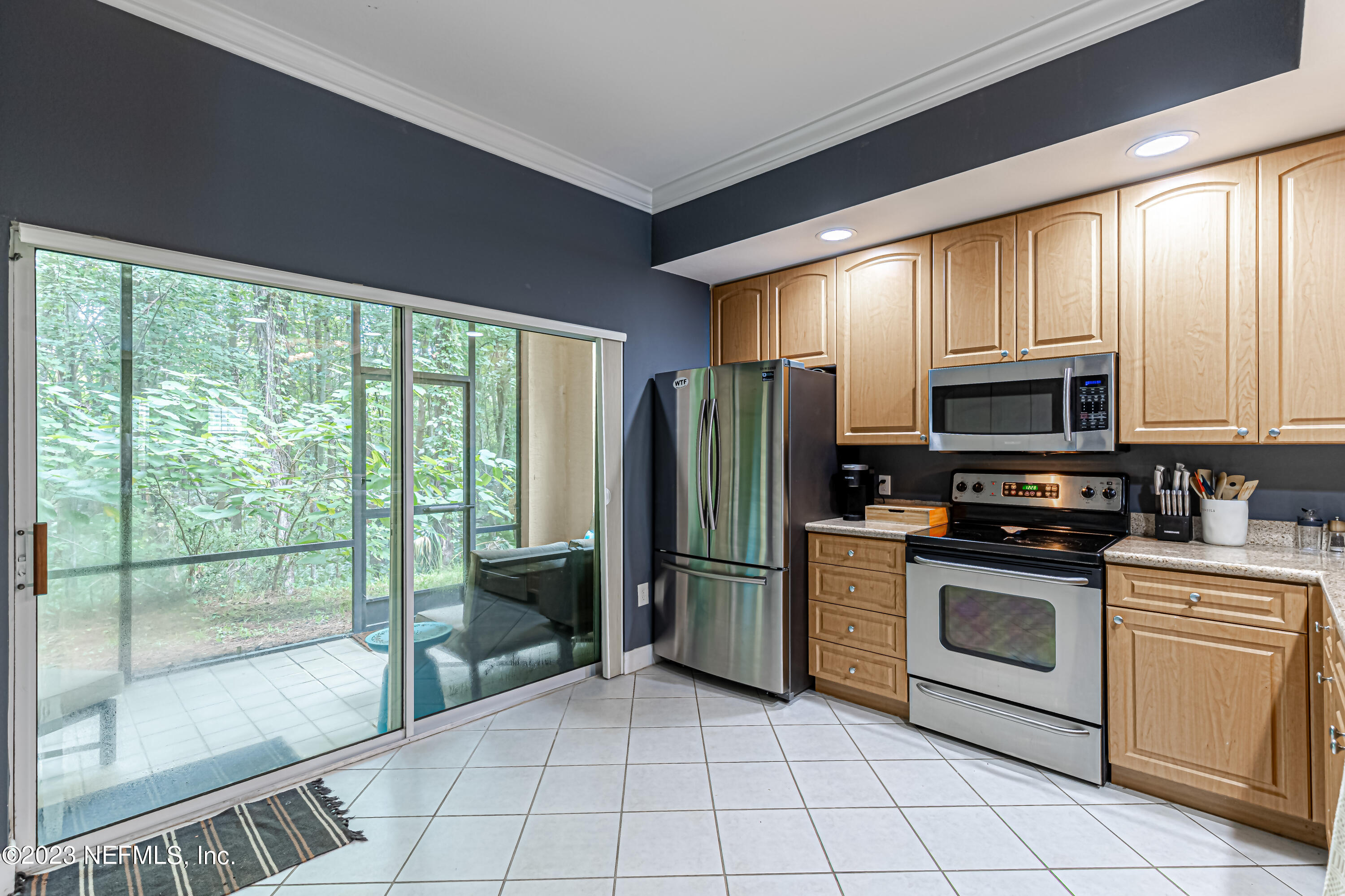 9745 Touchton Road, Unit 1105 Jacksonville, FL 32246 - Photo 12 of 64 a kitchen with stainless steel appliances granite countertop a refrigerator and a stove top oven