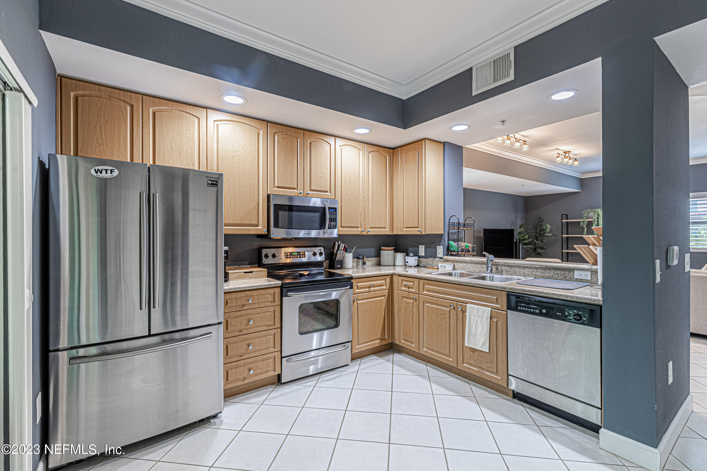 9745 Touchton Road, Unit 1105 Jacksonville, FL 32246 - Photo 13 of 64 a kitchen with stainless steel appliances granite countertop a refrigerator sink and stove
