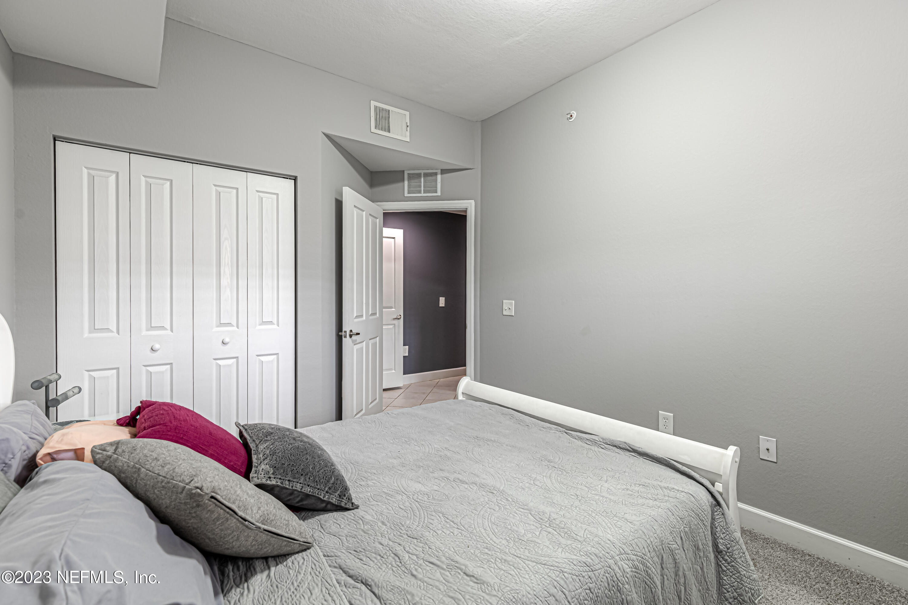 9745 Touchton Road, Unit 1105 Jacksonville, FL 32246 - Photo 17 of 64 a bedroom with a bed and a window