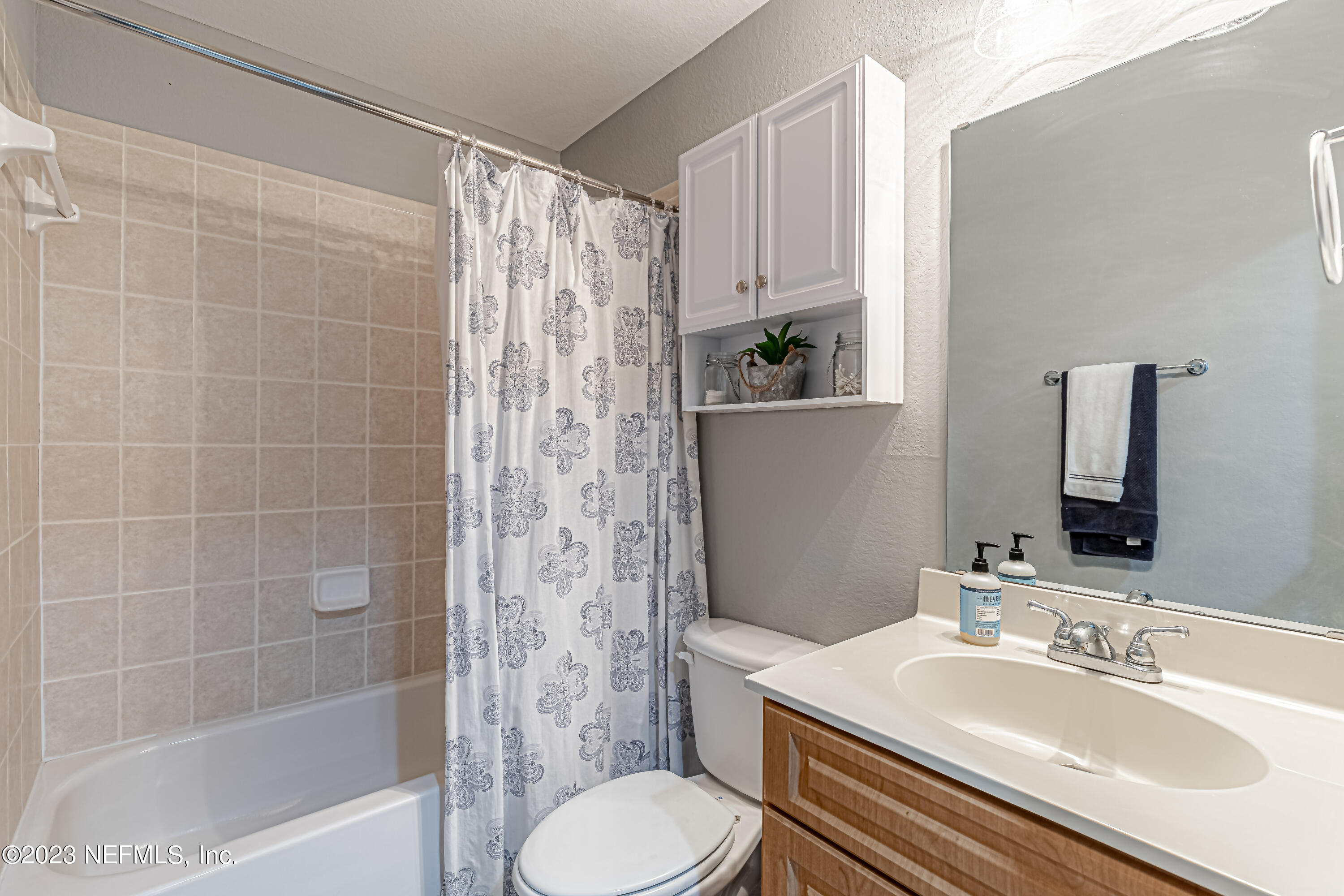 9745 Touchton Road, Unit 1105 Jacksonville, FL 32246 - Photo 20 of 64 a bathroom with a sink toilet and shower