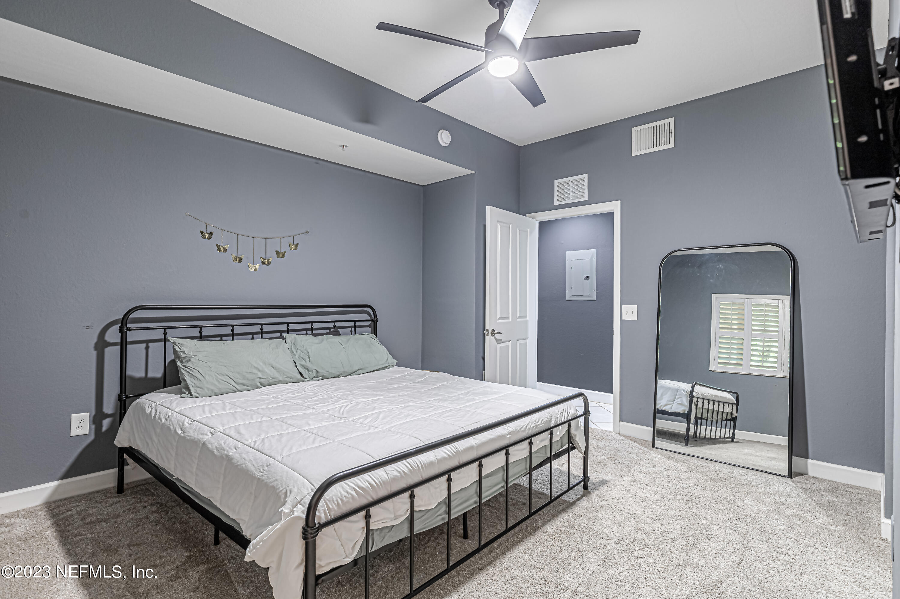 9745 Touchton Road, Unit 1105 Jacksonville, FL 32246 - Photo 22 of 64 a bedroom with a bed a mirror and furniture