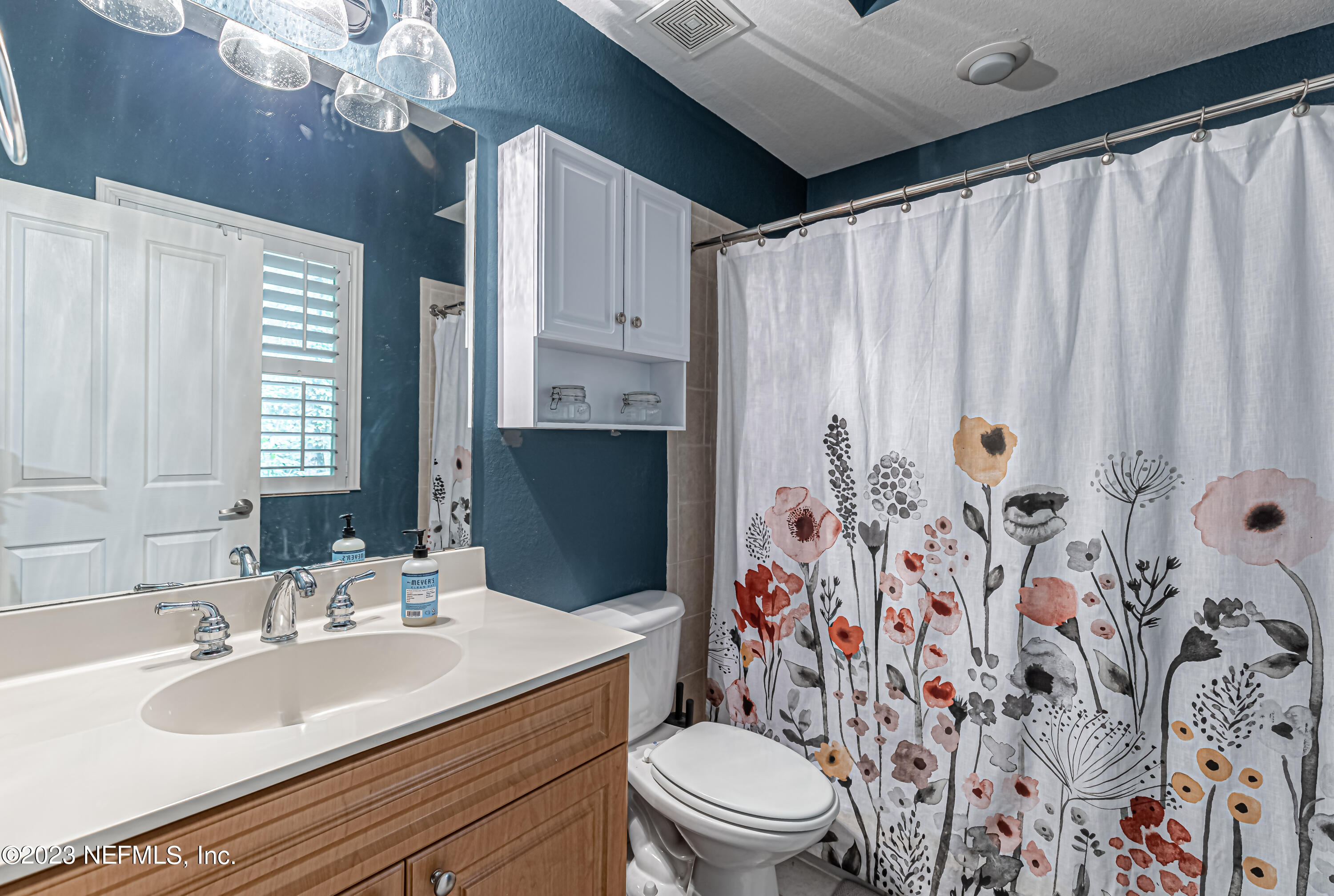 9745 Touchton Road, Unit 1105 Jacksonville, FL 32246 - Photo 24 of 64 a bathroom with a sink a toilet and shower curtain