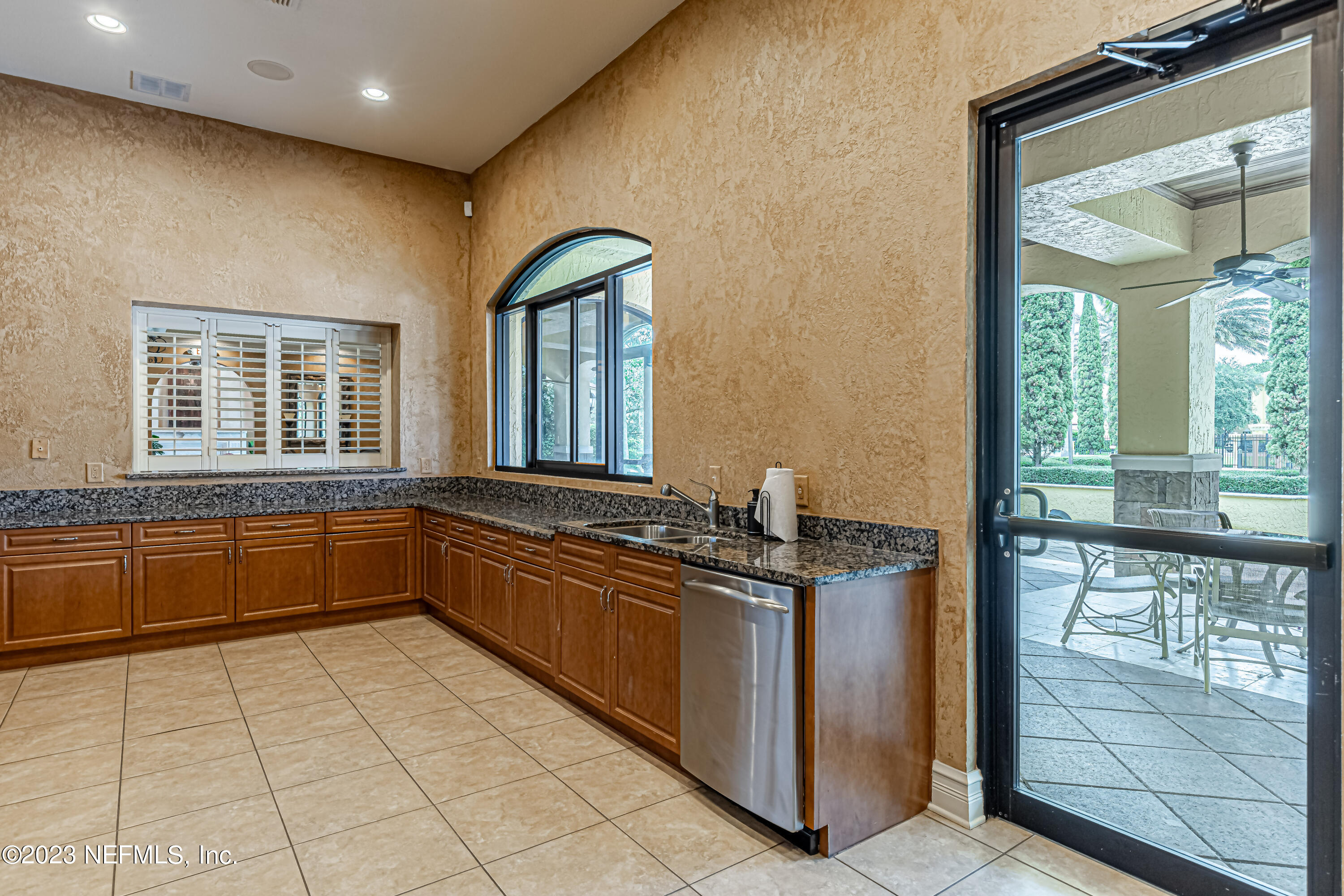 9745 Touchton Road, Unit 1105 Jacksonville, FL 32246 - Photo 33 of 64 a kitchen with stainless steel appliances granite countertop a stove a sink and a microwave