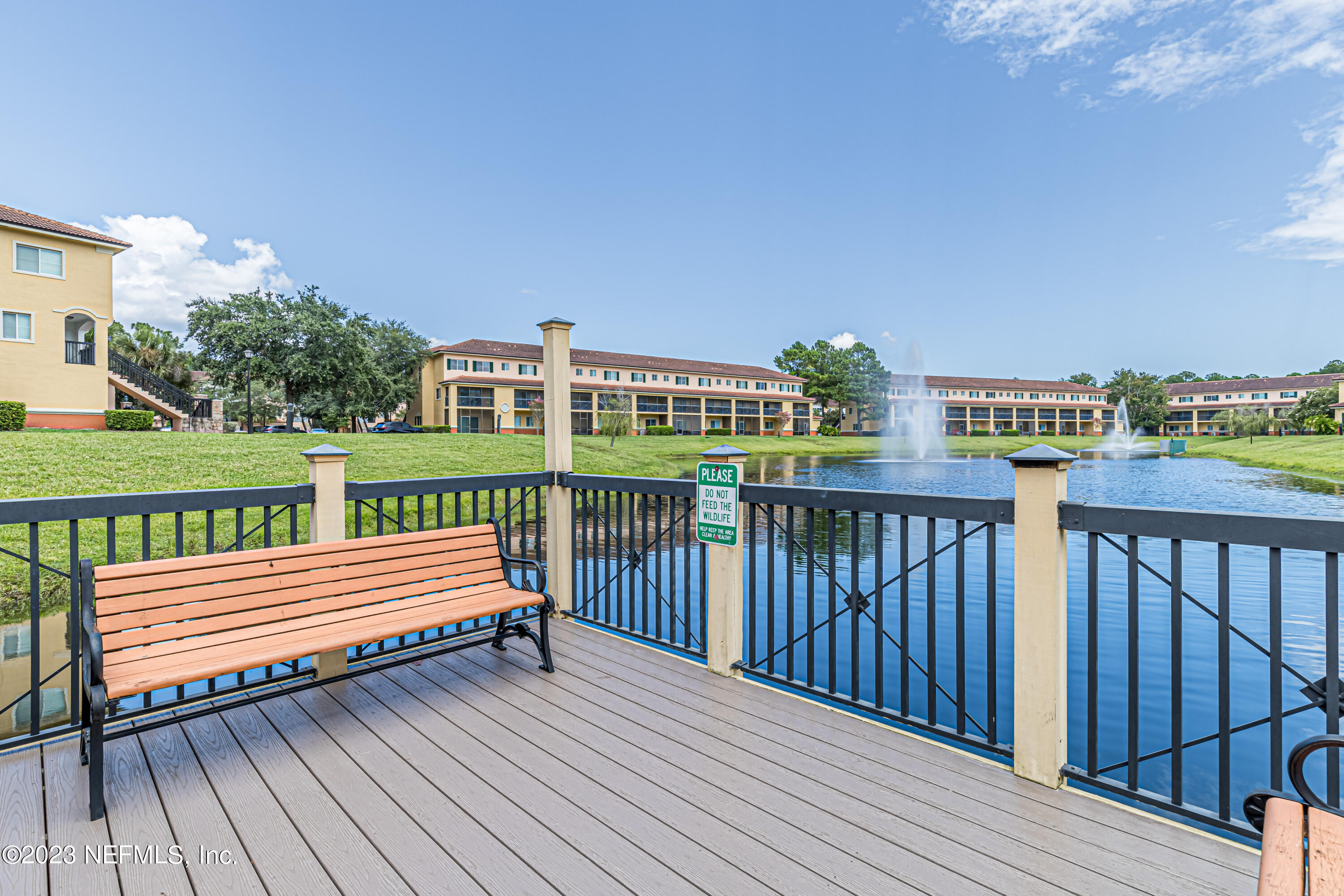 9745 Touchton Road, Unit 1105 Jacksonville, FL 32246 - Photo 40 of 64 a view of a wooden deck with a yard