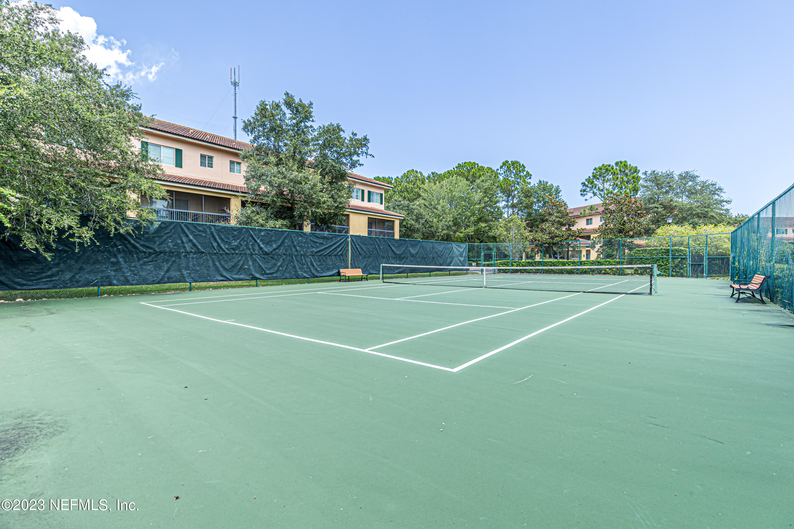 9745 Touchton Road, Unit 1105 Jacksonville, FL 32246 - Photo 41 of 64 a view of a tennis ground with a large trees