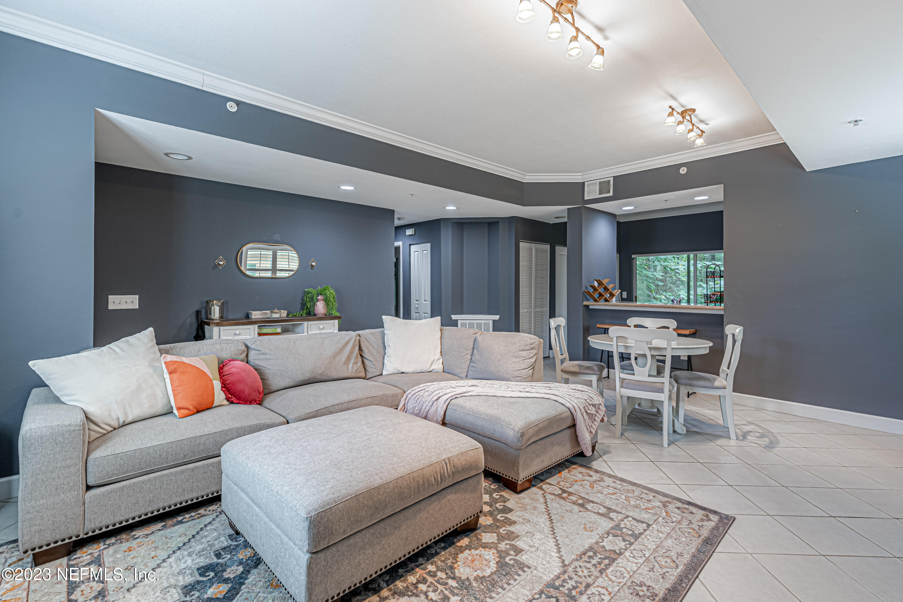 9745 Touchton Road, Unit 1105 Jacksonville, FL 32246 - Photo 6 of 64 a living room with furniture and a chandelier