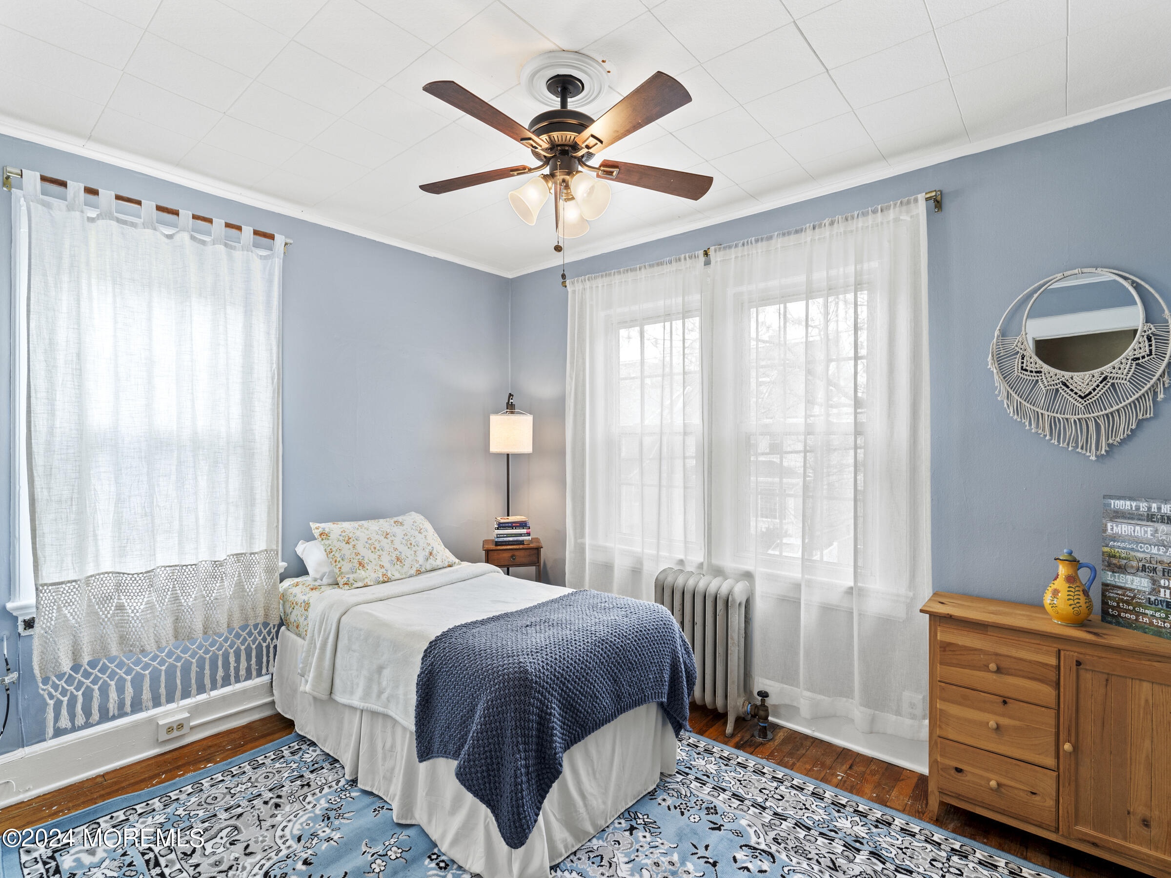 150 State Street Bloomfield, NJ 07003 - Photo 16 of 30 a bedroom with a large bed and a chandelier