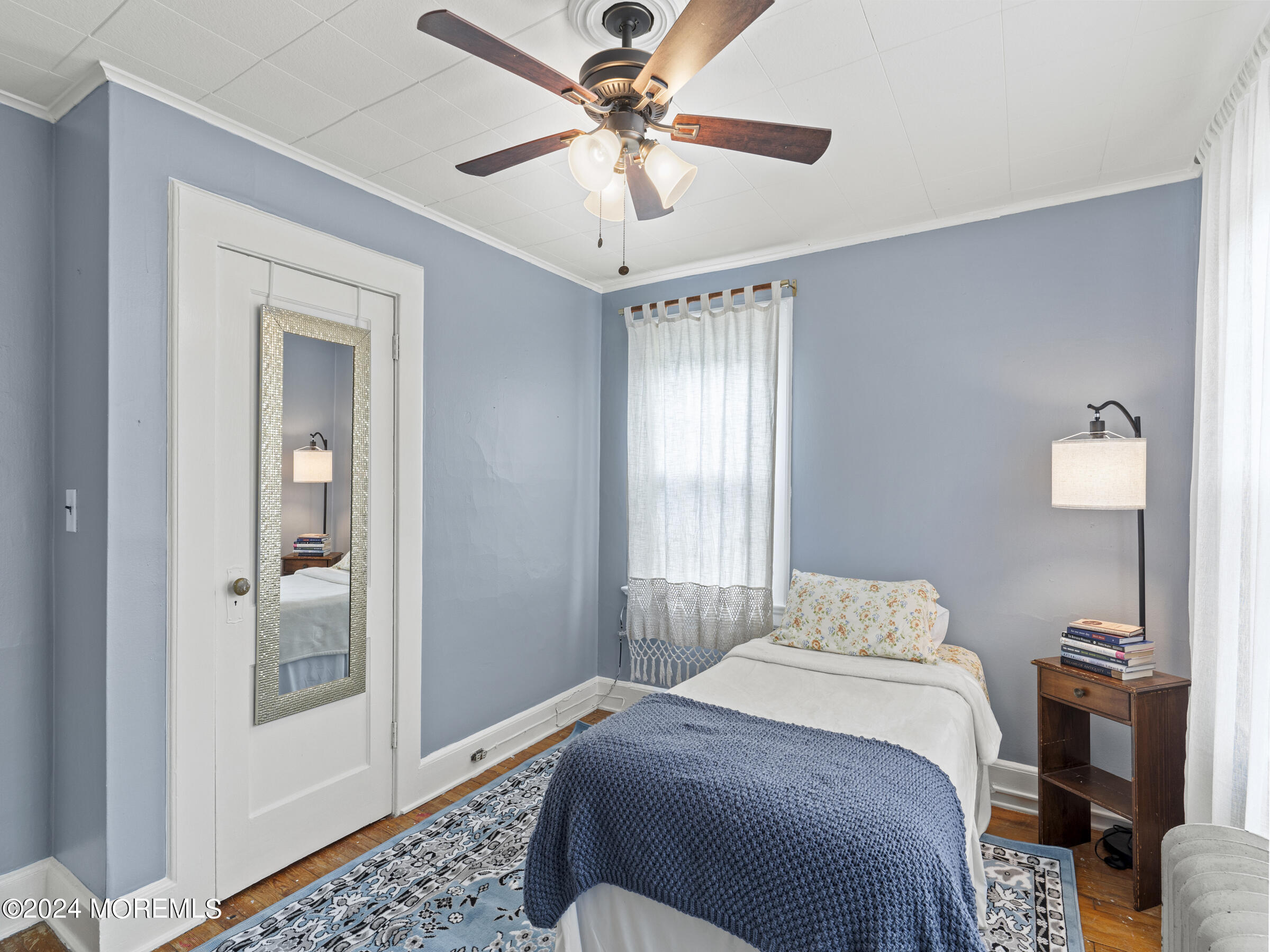 150 State Street Bloomfield, NJ 07003 - Photo 17 of 30 a bedroom with a bed and a chandelier