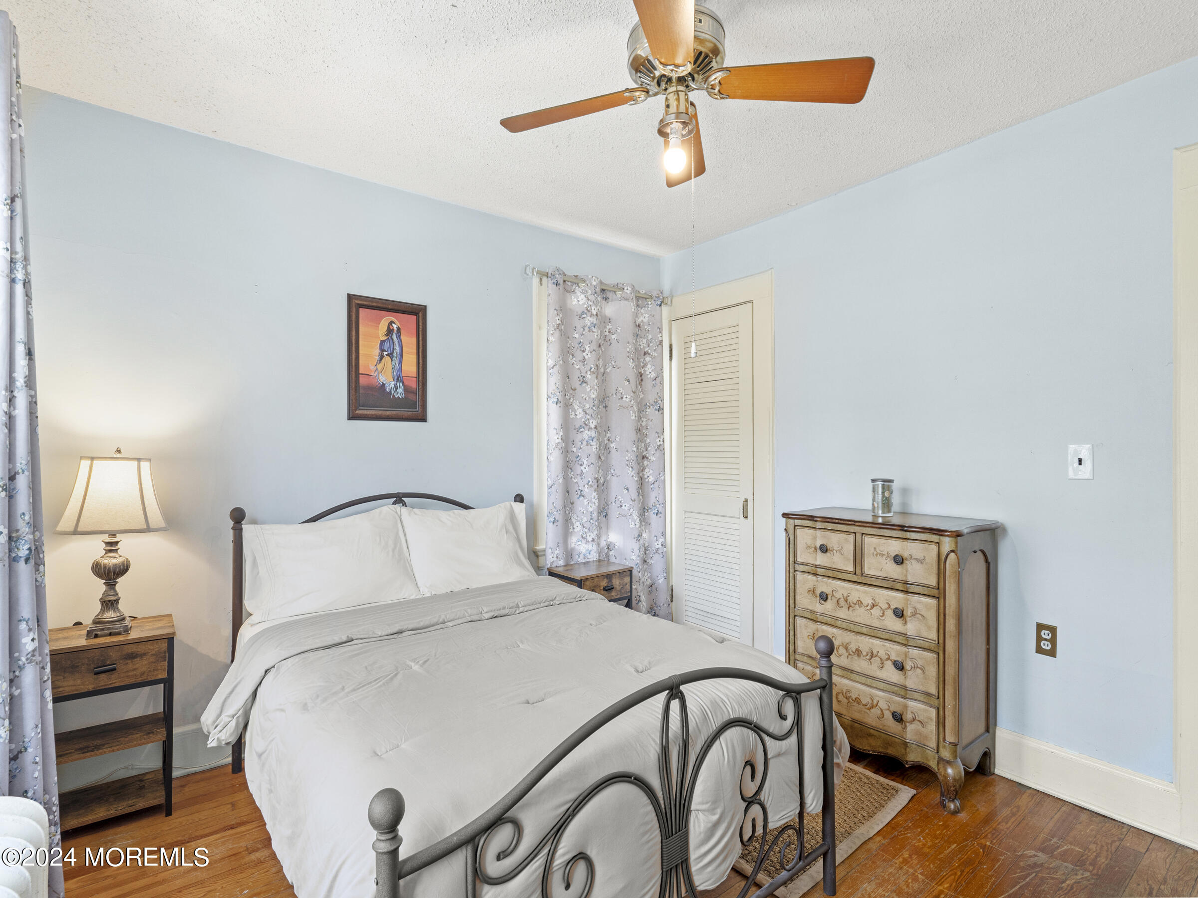 150 State Street Bloomfield, NJ 07003 - Photo 21 of 30 a bedroom with a bed and a chandelier