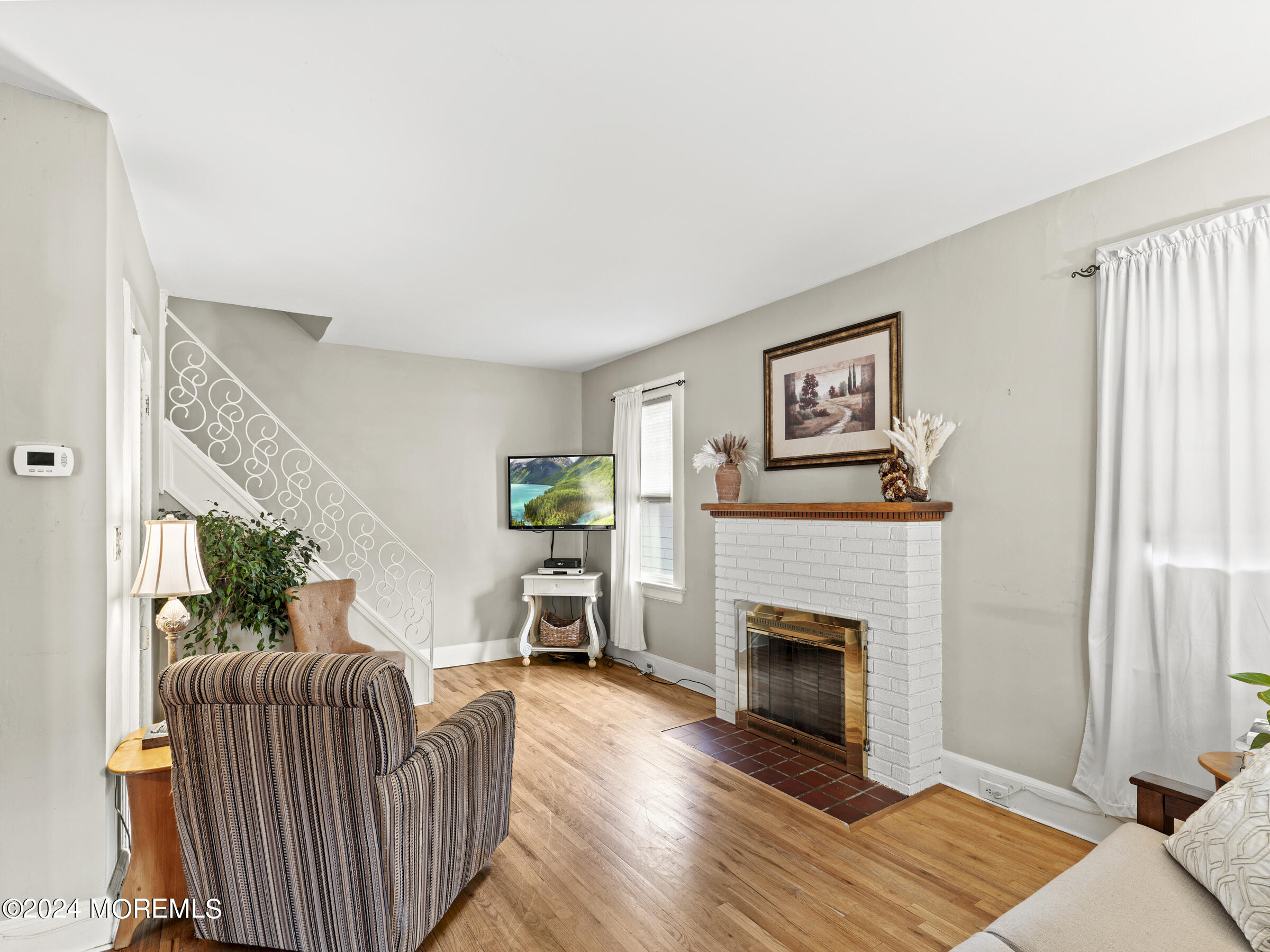 150 State Street Bloomfield, NJ 07003 - Photo 5 of 30 a living room with furniture and a fireplace