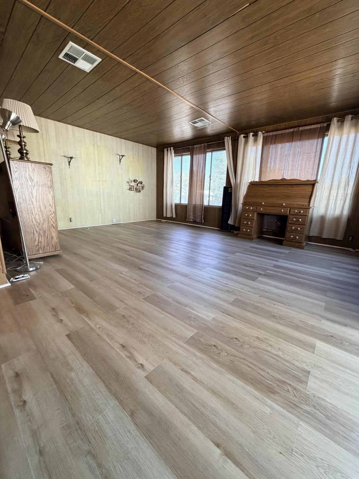 1449 Menomenee Lane, Unit 252 Redding, CA 96003 - Photo 12 of 18 a view of an empty room with window and wooden floor