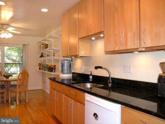 2074 Golf Course Drive Reston, VA 20191 - Photo 14 of 30 a kitchen with granite countertop a sink a stove and cabinets