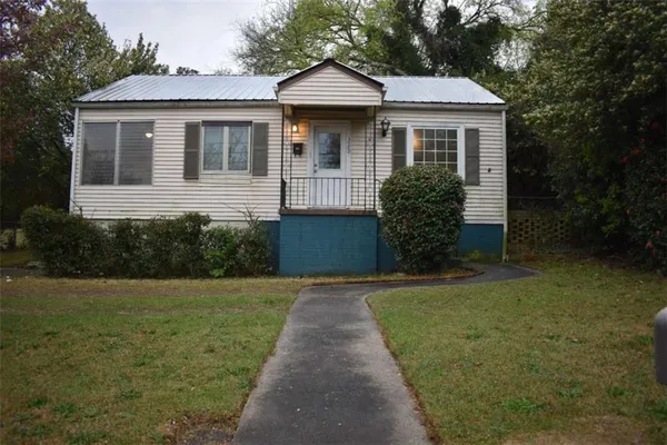 a front view of a house with garden