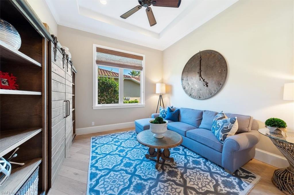 2147 Torino Way Naples, FL 34105 - Photo 15 of 31 a living room with furniture a flat screen tv and a window