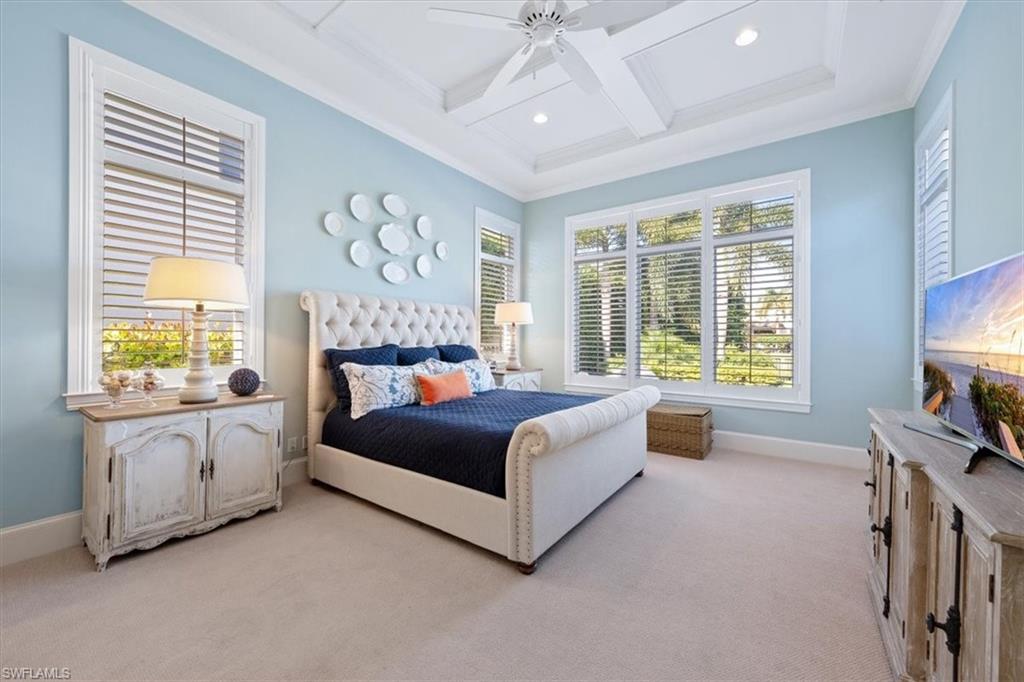 2147 Torino Way Naples, FL 34105 - Photo 19 of 31 a spacious bedroom with a large bed and a flat tv screen on dresser