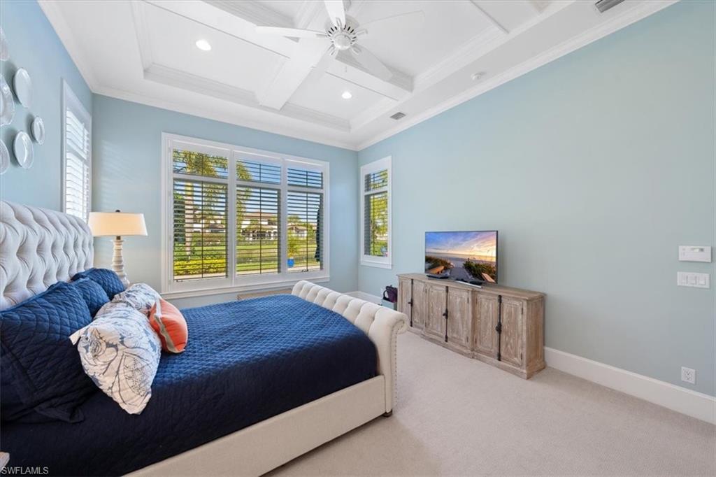 2147 Torino Way Naples, FL 34105 - Photo 20 of 31 a bed sitting in a spacious bedroom next to a window
