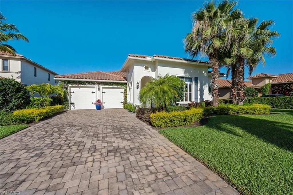 2147 Torino Way Naples, FL 34105 - Photo 2 of 31 a front view of a house with garden