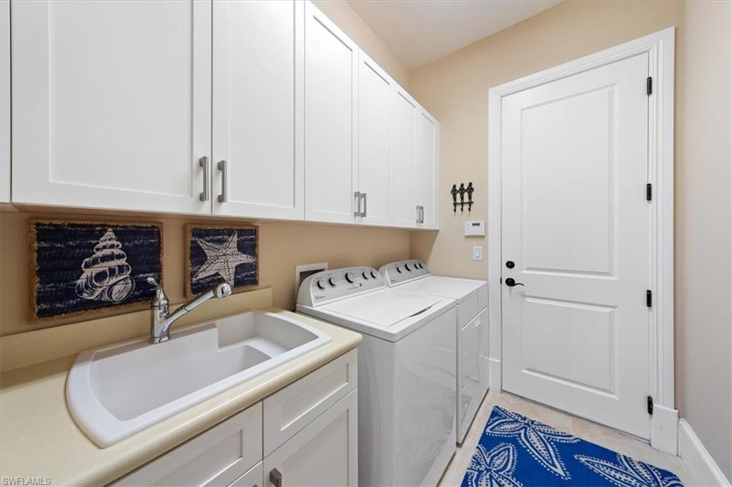 2147 Torino Way Naples, FL 34105 - Photo 25 of 31 a utility room with dryer and washer