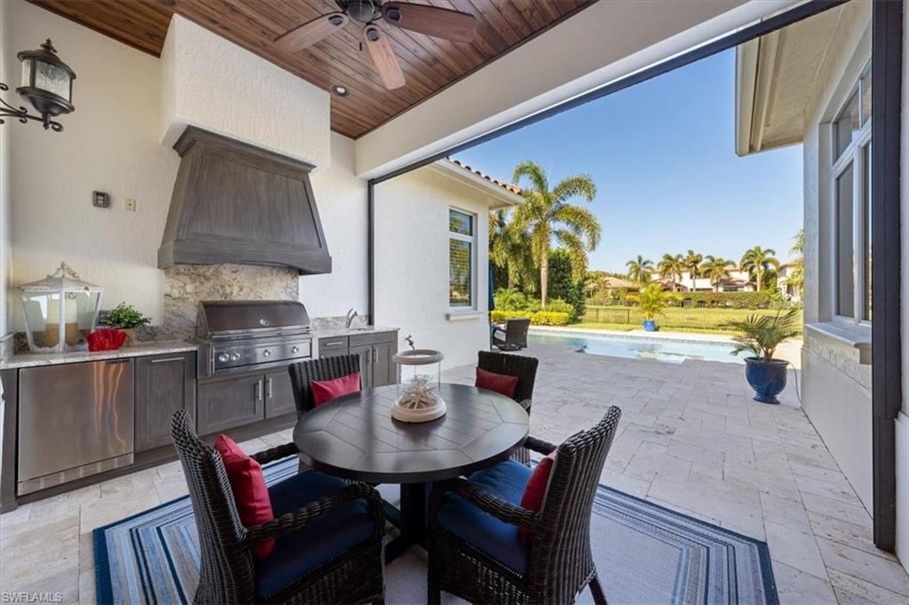 2147 Torino Way Naples, FL 34105 - Photo 26 of 31 a view of a dining room with furniture and chandelier