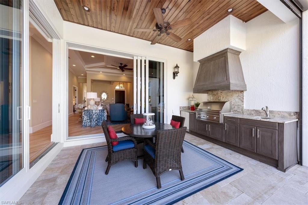 2147 Torino Way Naples, FL 34105 - Photo 27 of 31 a dining room with furniture and wooden floor