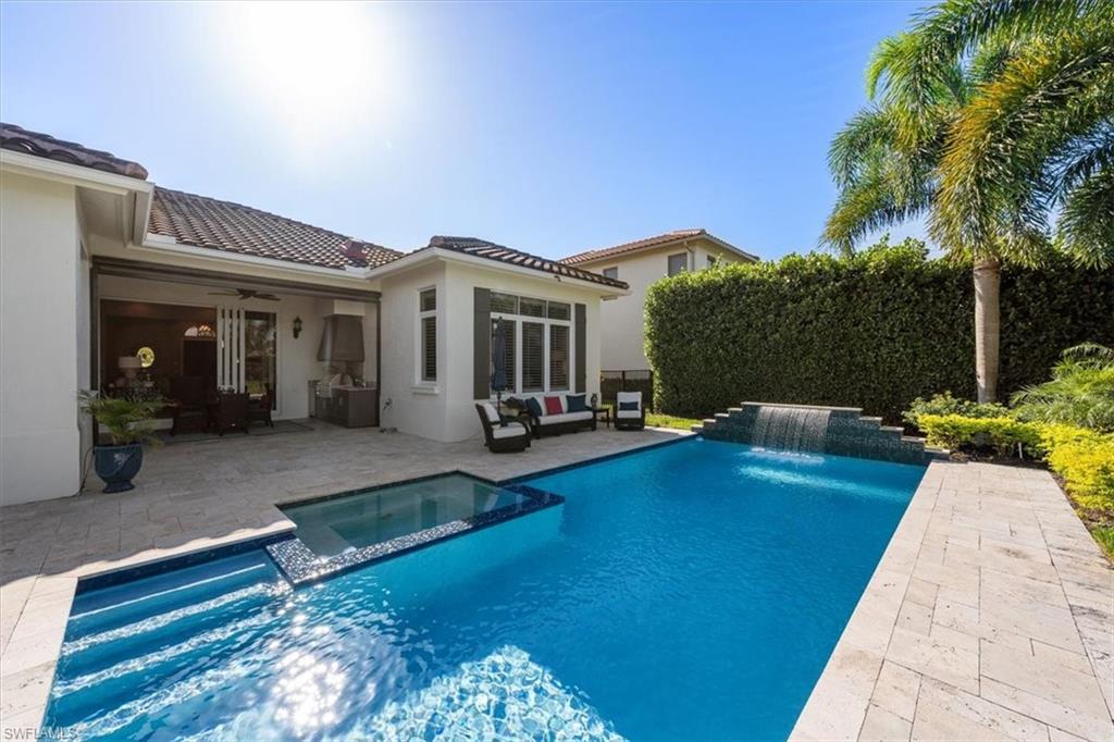 2147 Torino Way Naples, FL 34105 - Photo 28 of 31 a view of a house with swimming pool and sitting area