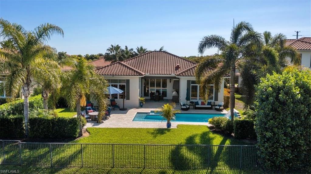 2147 Torino Way Naples, FL 34105 - Photo 30 of 31 a house view with a sitting space garden and patio