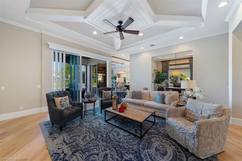 2147 Torino Way Naples, FL 34105 - Photo 4 of 31 a living room with furniture ceiling fan and a rug