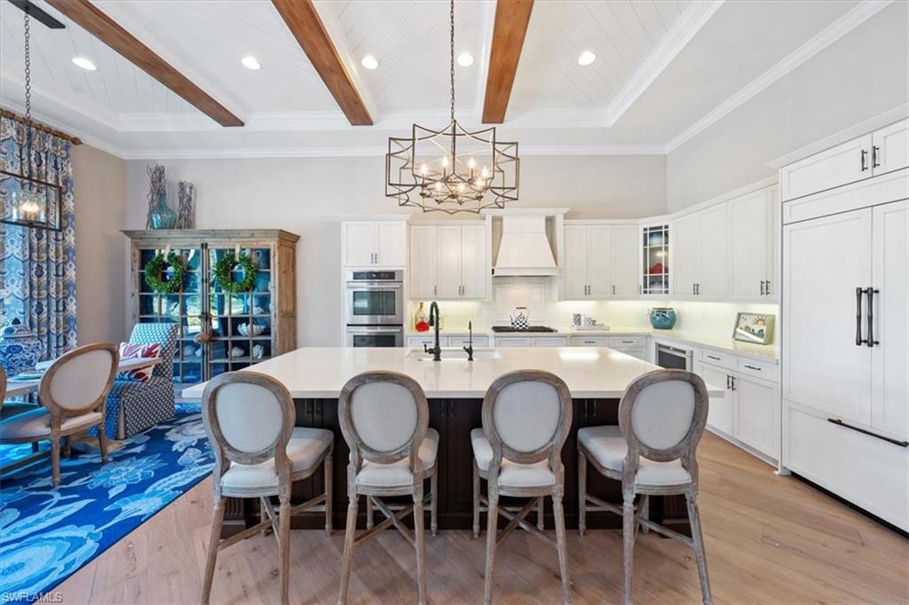 2147 Torino Way Naples, FL 34105 - Photo 9 of 31 a view of a dining room with furniture window and wooden floor
