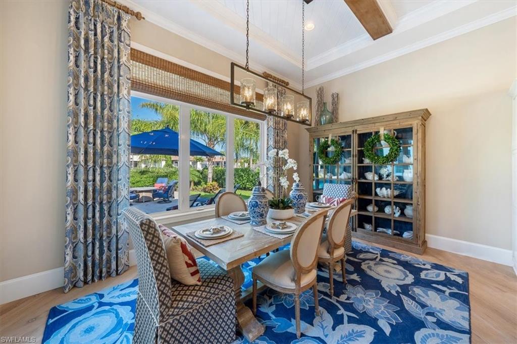 2147 Torino Way Naples, FL 34105 - Photo 10 of 31 a view of a dining room with furniture window and wooden floor