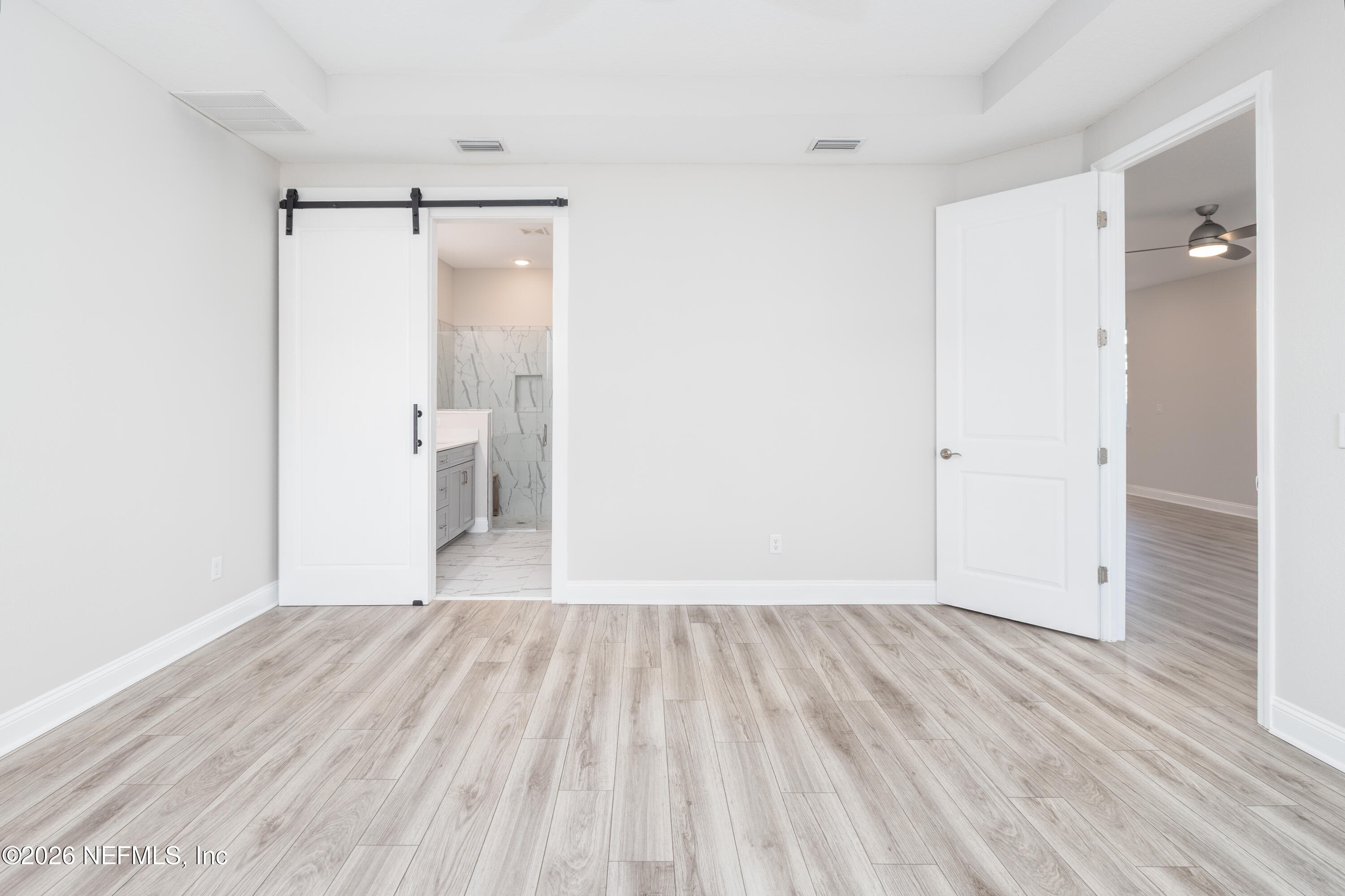 305 Kellet Way St. Johns, FL 32259 - Photo 15 of 42 a view of an empty room with wooden floor and a bathroom