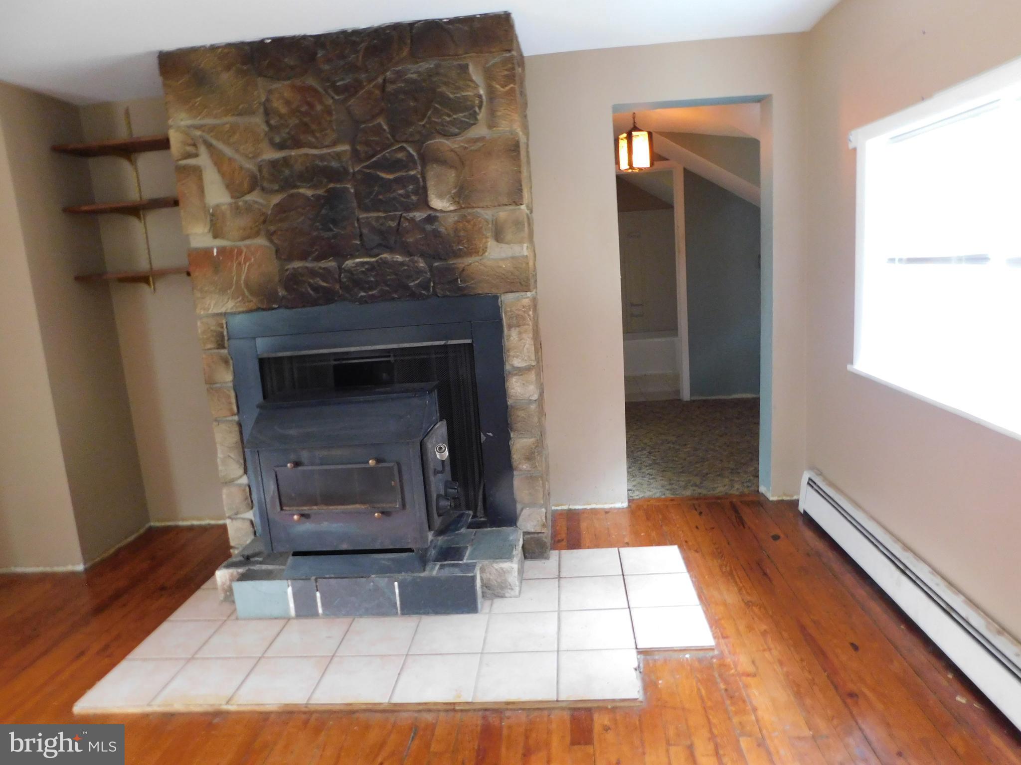 200 Old New Road Warrington, PA 18976 - Photo 15 of 54 Wood Burning Stove and Stone Back Drop