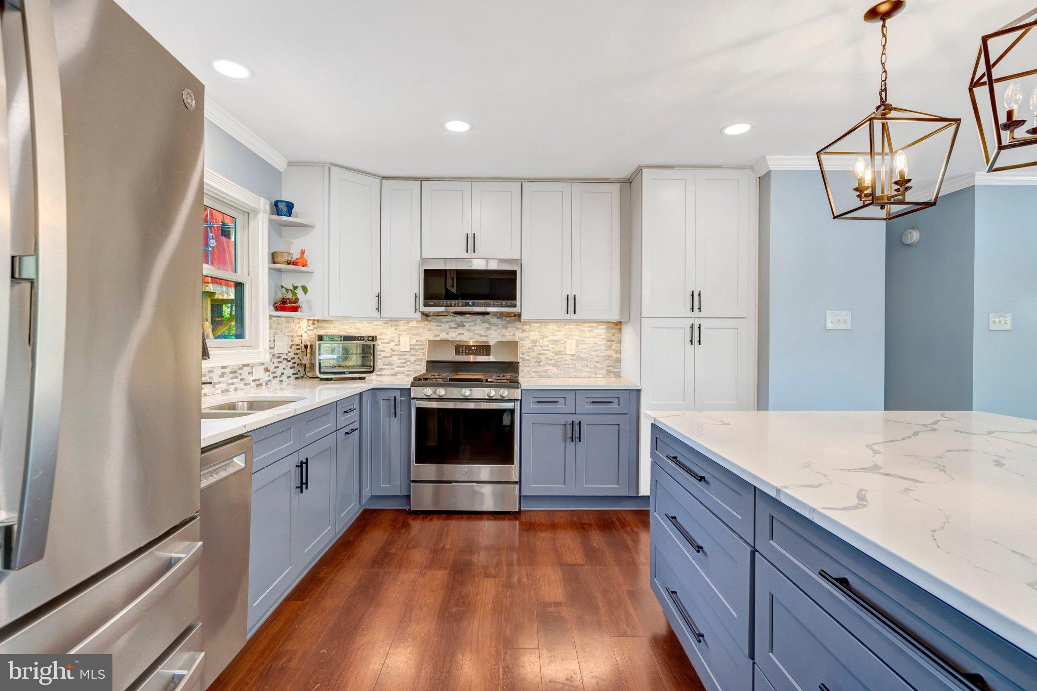 7212 Galgate Drive Springfield, VA 22153 - Photo 8 of 39 a large kitchen with stainless steel appliances granite countertop a stove refrigerator and a sink