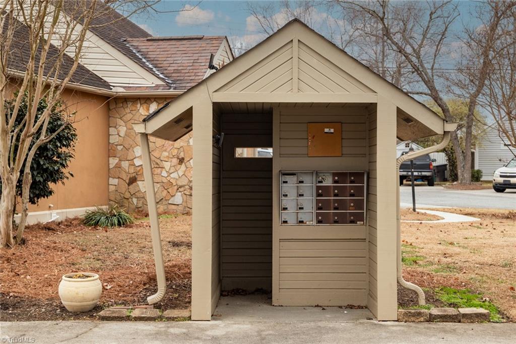 4204 Sunburst Drive High Point, NC 27265 - Photo 43 of 44 An earnest little mail kiosk, using a walking stick with one hand firmly on its hip.