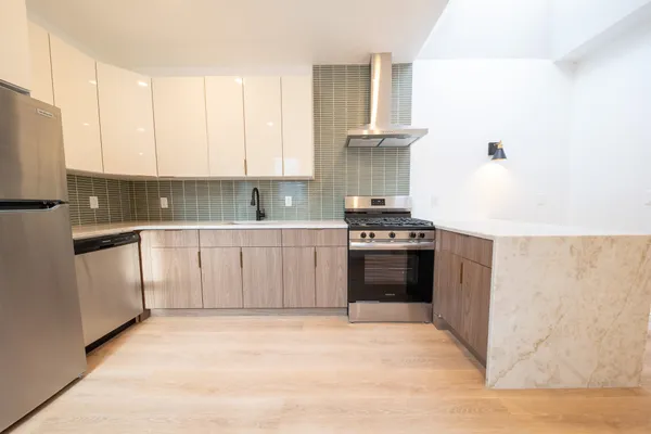 a kitchen with a stove a sink and a refrigerator