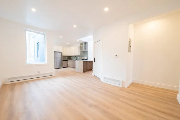 a view of a kitchen with a sink and a refrigerator