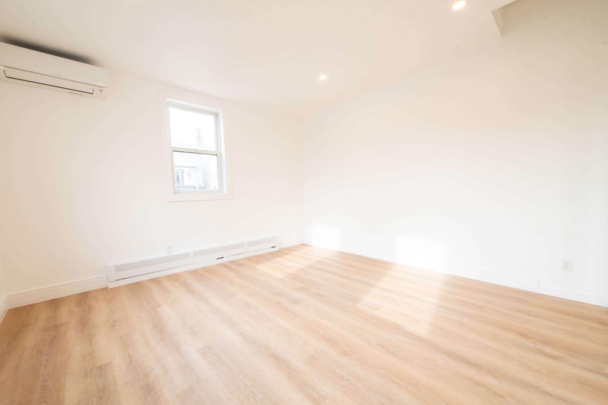 4525 Brown Street, Unit 2 Union City, NJ 07087 - Photo 5 of 12 a view of an empty room with wooden floor and a window