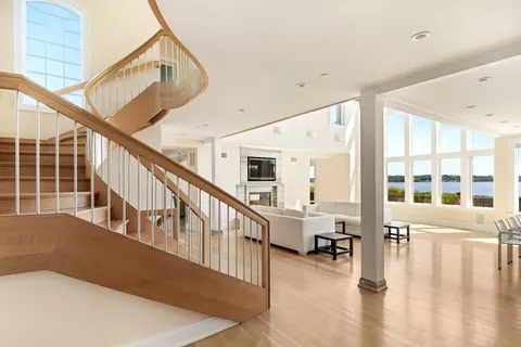 a view of an entryway with wooden floor and windows