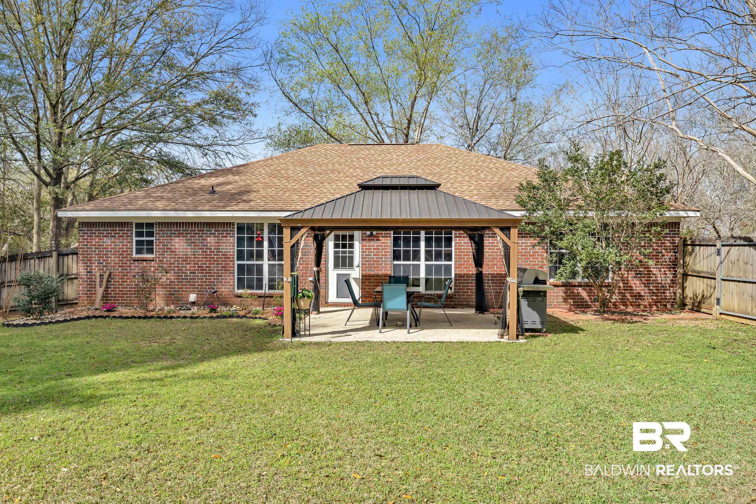 191 Robbins Boulevard Daphne, AL 36526 - Photo 19 of 24 Rear view of house with a fenced backyard, a patio, a gazebo, and brick siding