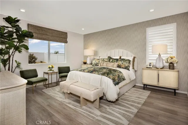 a bedroom with a large bed and a potted plant