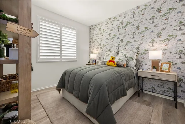 a bed sitting in a bedroom next to a window