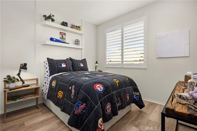 a bedroom with a bed and wooden floor